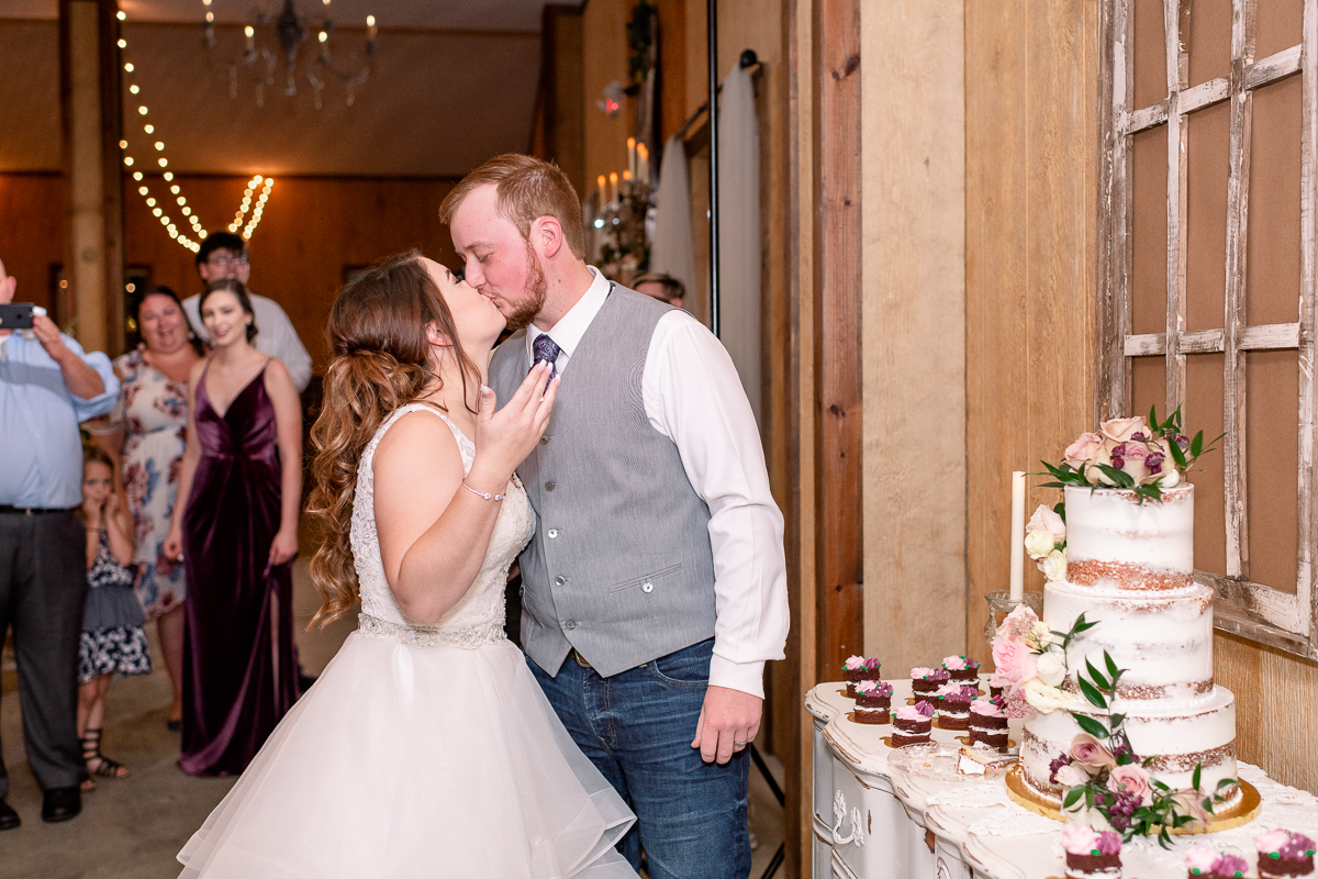 Bride and groom kissing after cake cutting | Orlando Wedding Photographer