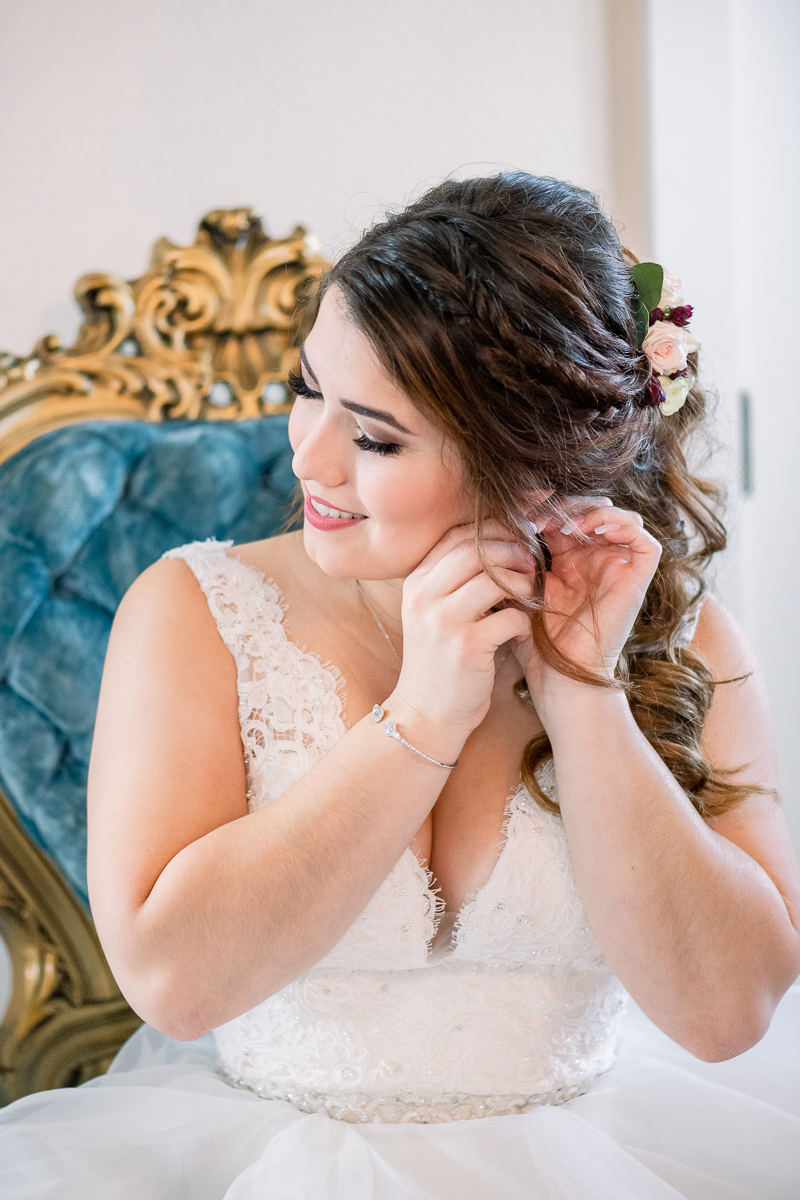 Bride putting on her earrings on wedding day | Orlando Wedding Photographer
