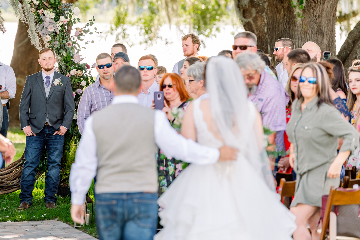 Groom watching bride walk down the aisle | Orlando Wedding Photographer