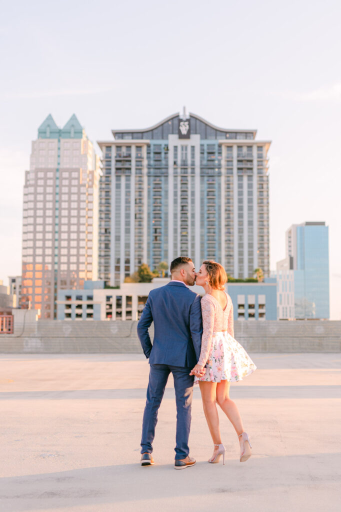couple kissing on downtown orlando rooftop