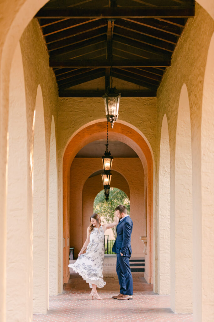couple twirling dressed formal at their engagement session in winter park
