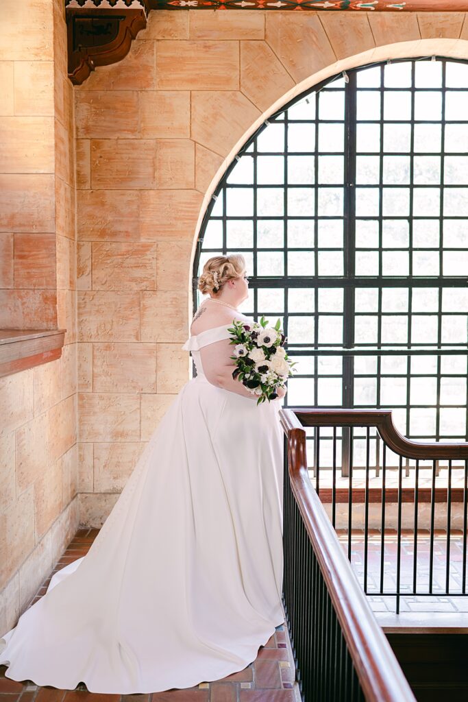bridal portraits in front of large window at the Treasury on the Plaza in St. Augustine